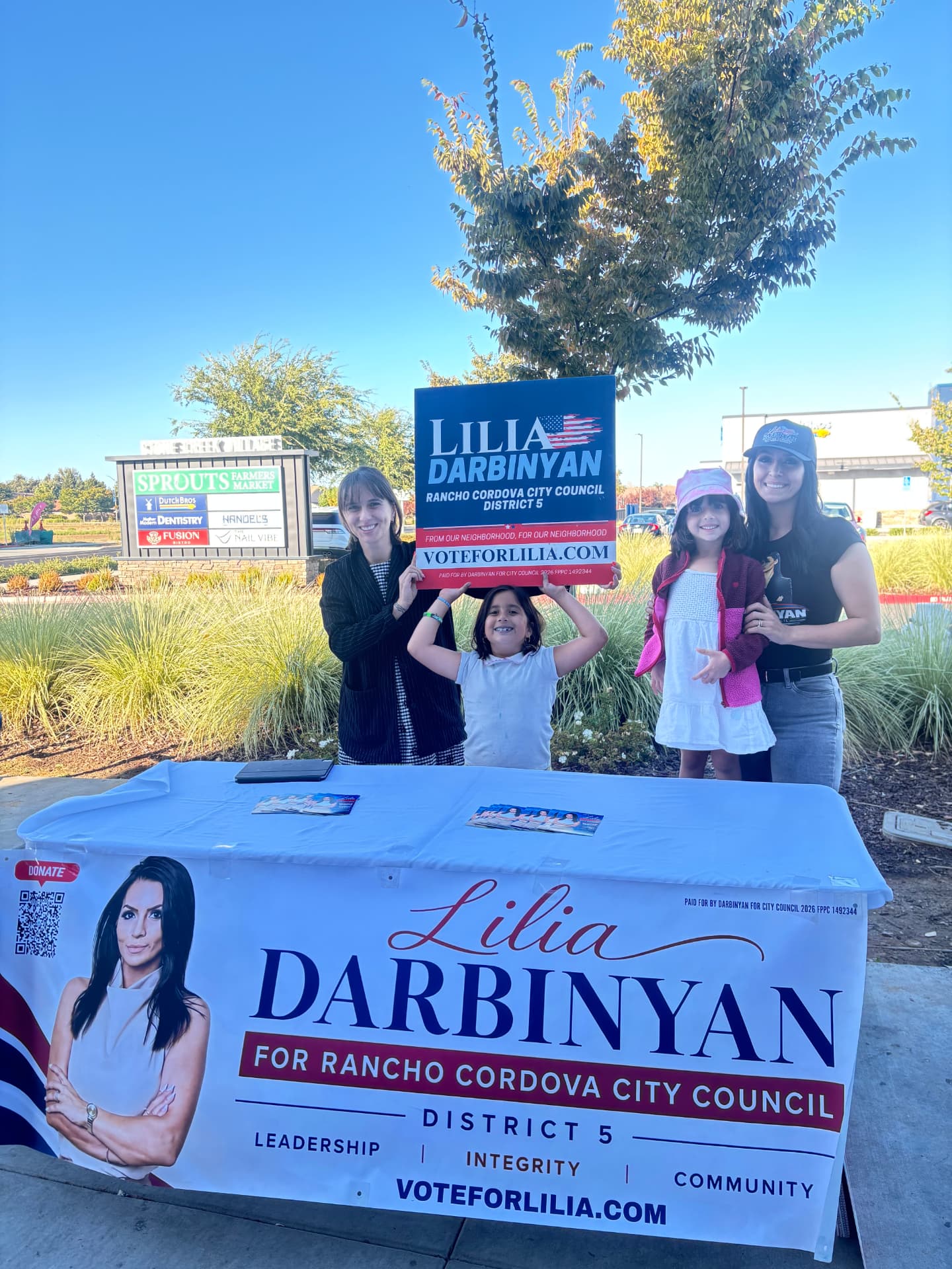 A family stopping by Lilia's campaign booth